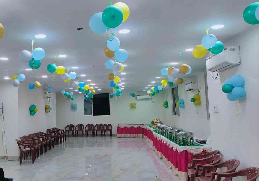 Annaprashan venue decorated with balloons and clean buffet setup by Gharoa Catering.